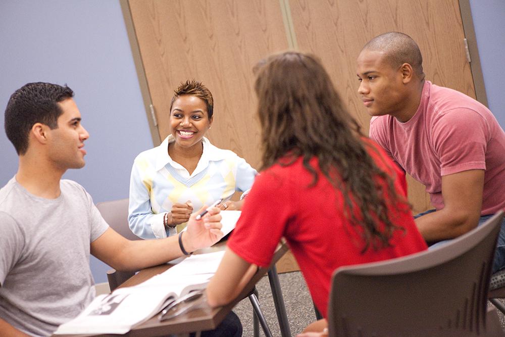 Students at table discussing social sciences